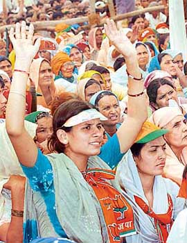A young woman raises slogans at an election rally