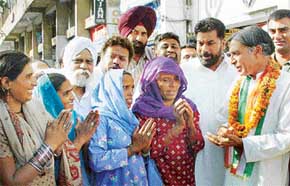 Mr Pawan Kumar Bansal, Congress candidate, interacts  with women in Sector 22, Chandigarh, on Monday. 
