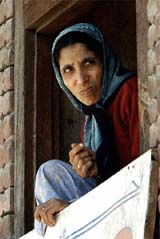 A Kashmiri woman listens to a speech during an anti-election rally in Anantnag, 55 km south of Srinagar, on Tuesday. 