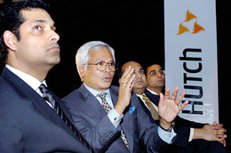 Managing Director of Hutchinson Max Asim Ghosh gestures and is looked on by Managing Director of Microsoft India Rajiv Kaul as he answers a question during the launch of Microsoft Outlook on Hutch mobile phones