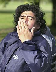 Former Argentine football star Diego Maradona blows a kiss to fans at the front door of a private home of General Rodriguez