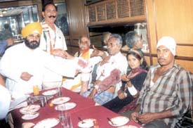 Congress activist Paramjit Singh Pamma and the party candidate from the Moti Nagar assembly constituency with a few injured persons at a press conference