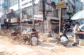 A HAWKER IN A POTHOLE