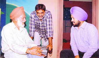 (From right) Gurpreet Ghuggi with Sukhwant Dhadda and Charan Singh Safri