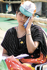Trying to beat the heat: A Congress supporter at the party’s last election rally at Ramlila Ground in the Capital on Saturday.