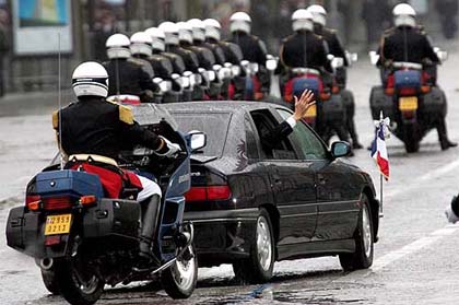French President Jacques Chirac waves from his car as he leaves Arc de Triomphe in Paris 
