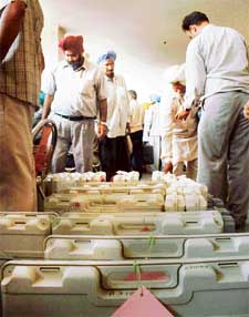 Polling officials inspect electronic voting machines in Ludhiana
