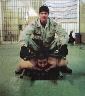 This picture, obtained by the New York Times from an undisclosed source, shows a US soldier sitting on an Iraqi detainee