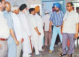 Mr B.B. Mohanty, election observer, checks a polling booth at Gian Jyoti Public School, Phase II, Mohali