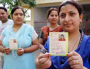 Voters whose names were missing from the poll rolls show their photo I-cards in Udhampur
