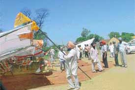 Residents of Sahauli village in the Kila Raipur Assembly segment uproot tents outside a polling station following the murder of SAD leader Jagpal Singh