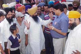 The SAD-BJP alliance candidate, Mr Sharanjit Singh Dhillon, argues with a Congress worker in the Field Ganj area following reports of high-handedness