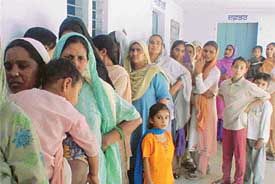 Women voters queue up for their turn at Dhapei village in Ludhiana 