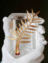 An employee of Chopard jewellers holds the Cannes Film Festival Palme dOr 2004 on the eve of the opening of the 57th Cannes Film Festival, on Tuesday. 