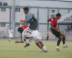 JCT Phagwaras Harvinder Singh and Mahindra United goalkeeper Naseem Akhtar in a tussle for supremacy in the eighth National Football League match at Ludhianas Guru Nanak Stadium 