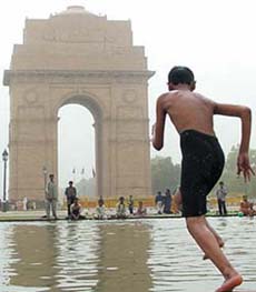 A child takes a dip at the India Gate in the Capital on Wednesday