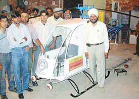 The mechanical engineering students and Mr Gurbhej Singh (right) with their creation, Mech Y-350. 