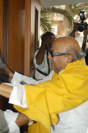 WE DID IT: DMK President M. Karunanidhi in a jubilant mood as he arrives at his party headquarters in Chennai on Thursday. 