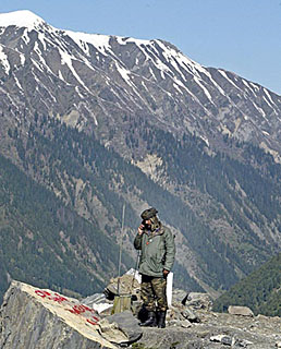 A soldier talks on a wireless radio to know the status of a convoy after the Srinagar-Leh highway was opened in Captain Morh, 105 km east of Srinagar on Thursday. The 440-km highway was opened by the Indian Army for traffic after it remained snowbound at Zoji La, 3,530 m above sea level, for more than six months.