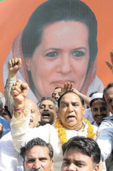 The DPCC president celebrating with party workers outside 10 Janpath in the Capital on Friday.