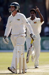 Zimbabwean batsman Brendon Taylor returns to the pavilion after being dismissed by Sri Lanka bowler Chaminda Vaas for five runs in Bulawayo