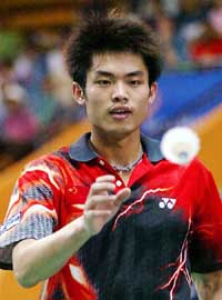 Lin Dan of China changes the shuttlecock during the match against Lee Hyun-li of South Korea at the mens singles semifinal in the Thomas Cup Badminton Championships