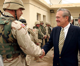 Secretary of Defence Donald Rumsfeld shakes hands with US soldiers at Abu Ghraib prison outside Baghdad on Thursday.
