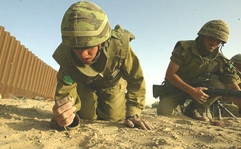 Israeli soldiers search for the body parts of troops