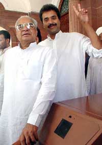 Newly elected MP from Bhiwani Kuldeep Bishnoi with father Bhajan Lal in front of the Parliament House in New Delhi