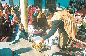 Members of Samridhi  being trained by the experts in a village to prepare the pickles