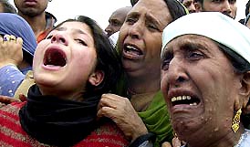 Relatives wail during a demonstration against the arrest of three youths in Srinagar 