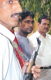 Rakesh Kumar Kashyap (C) arrested for threatening businessmen by sending e-mails and letters, masquerading as an Al-Qaida member in the Capital on Monday.
