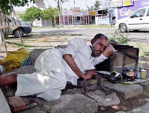 A cobbler takes a nap under a tree in a hot afternoon in Ambala 