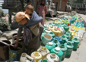 A woman waits for a water tanker in Chakkar, near Shimla, on Tuesday.