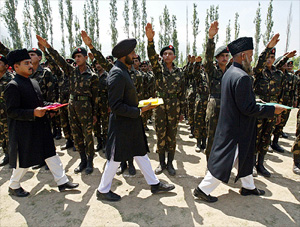 A Muslim priest (from R), a Sikh priest and a Hindu priest at the oath-taking ceremony of Territorial Army soldiers in Khrew, 25 km south of Srinagar, on Tuesday. 