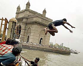 Street children cool off in sea waters