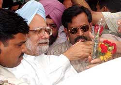 PM-designate Manmohan Singh being greeted at his residence in New Delhi on Thursday
