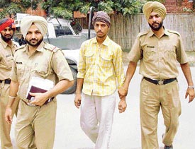 Pritpal Singh (centre) being brought to the office of the SSP, Mohali, on Thursday after being arrested for killing his elder sister.