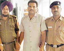 Uttar Pradeshs most- wanted criminal Ran Pal Singh Gujjar in police custody in Chandigarh on Thursday. 
