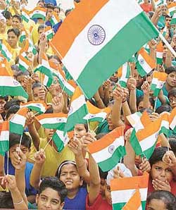 Children wave the National Flag on the death anniversary of Rajiv Gandhi, observed as Anti-Terrorism Day, at Stepping Stones School in Sector 38, Chandigarh, on Friday. 