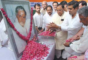 Delhi Sadar MP Jagdish Tytler and DPCC president Ch Prem Singh paying homage to Rajiv Gandhi at DPCC office in the Capital Friday. 