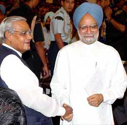Former Prime Minister Atal Bihari Vajpayee greets newly-appointed Prime Minister Manmohan Singh after the swearing-in ceremony in New Delhi