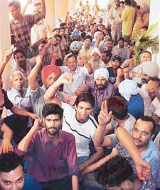 NRMU members hold a dharna outside the office of a railways official in Ludhiana on Saturday