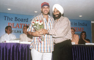 Delhi and District Cricket Association joint secretary Dr S S Sareen hugging former Test player Maninder Singh at the Platinum Pension Scheme of the Board of Control for Cricket in India.