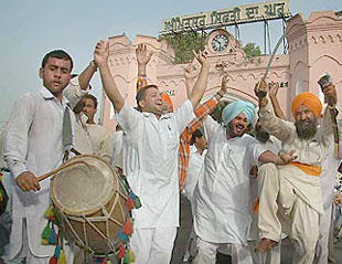 People perform bhangra in Amritsar to celebrate the swearing-in of Dr Manmohan Singh as the Prime Minister, on Saturday.