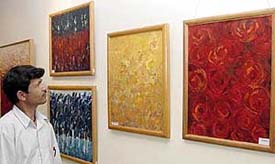 A visitor looks at a painting exhibition in the IndusInd Bank. Photo: Parvesh Chauhan 