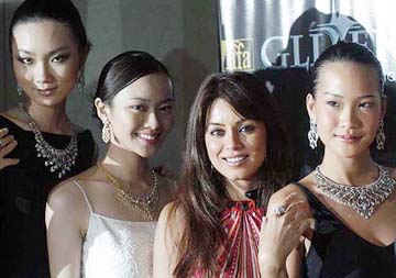 Bollywood actress Mahima Choudhary poses with models at the launch of D'DAMAS Glitaratti collection in Singapore