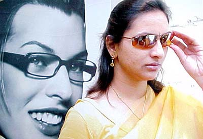 A customer selects sunglasses from the newly opened Kodak Lens Vision centre by Himalaya Optical in Jalandhar 