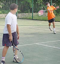 Arjun Sehgal plays a shot while his partner Harry Singh looks on in the doubles event of the AITA talent series tennis tournament played at the CLTA tennis stadium on Wednesday.