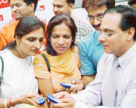 Mr Vinod Sawhney, Chief Executive Officer and Director, Mobility, Bharti Mobile Ltd, presents handsets with pre-activated SMS-based confidence plan to the hearing impaired women in Chandigarh 